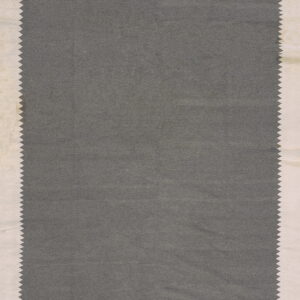 A solid dark gray sample with flat texture and zig-zag edges, framed by a light cream border.