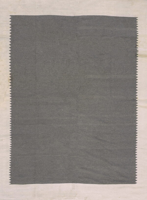 A solid dark gray sample with flat texture and zig-zag edges, framed by a light cream border.