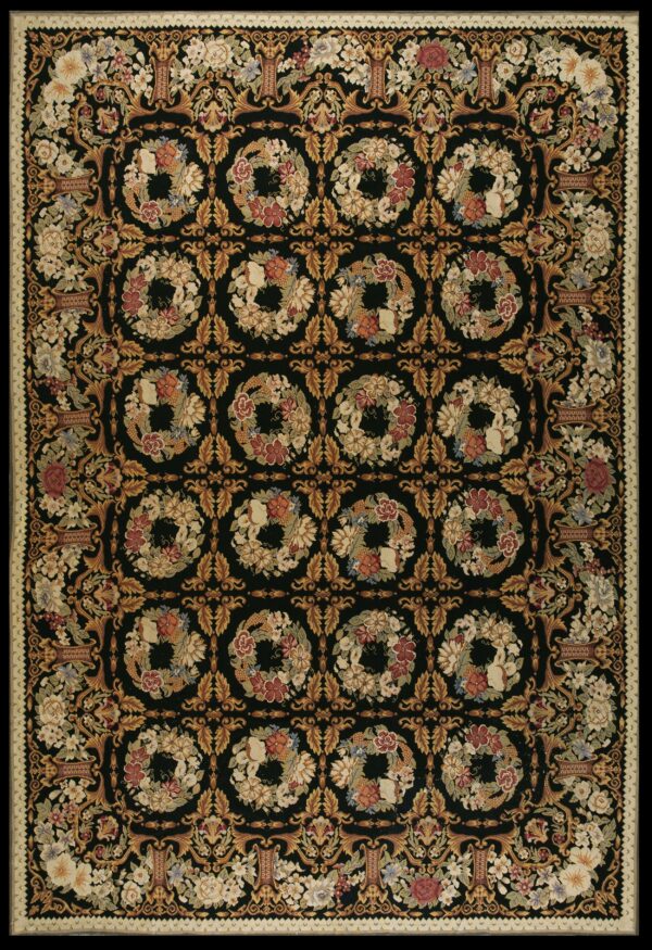 Ornate black area rug densely patterned with golden vines, floral urns, and repeating botanical wreaths.