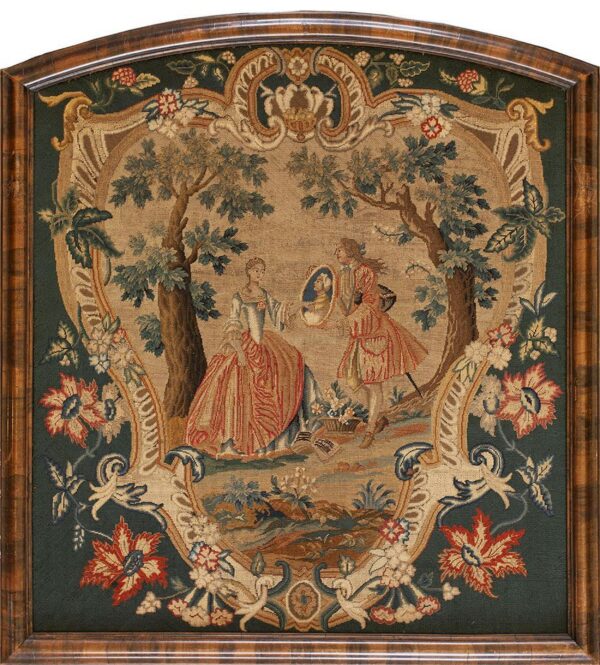 Low-pile framed textile featuring two figures in a tan wooded scene bordered by dark green floral scrollwork.