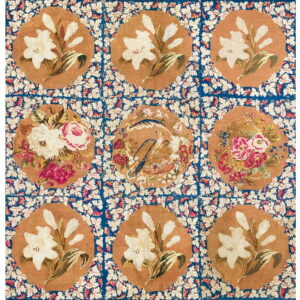 Nine floral medallions in tan and off-white set within a vibrant blue, leaf-patterned grid.