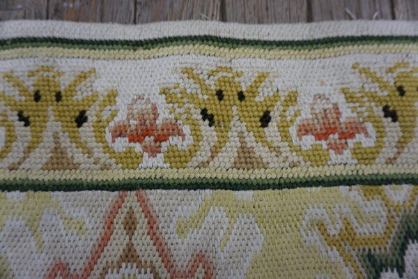 Colorful floral needlepoint rug detail