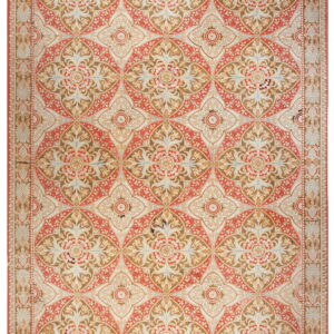 Ornate rug with repeating trellis, floral, and medallion motifs in red, brown, and cream colors.