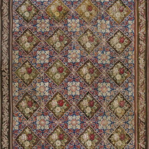 Ornate needlepoint-style rug featuring a brown, blue, and red diamond lattice filled with floral bouquets.