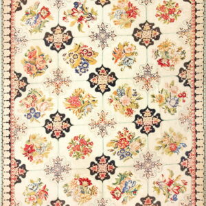 Ivory rug with a colorful repeating floral bouquet pattern contained within a dark geometric grid.