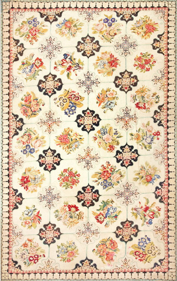 Ivory rug with a colorful repeating floral bouquet pattern contained within a dark geometric grid.
