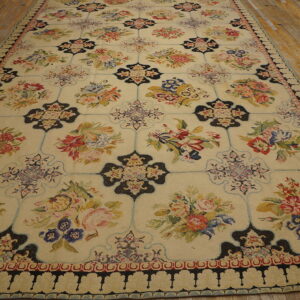Long cream rug featuring repeating colorful floral bouquets and black quatrefoil motifs on light wood floors.