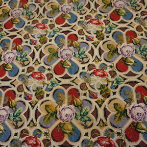 Multi-colored low pile rug displays purple and red flowers against a cream gothic-style geometric trellis.