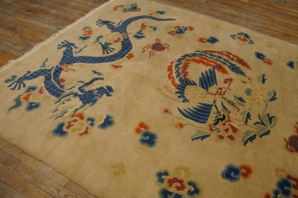 Beige high-pile rug displaying a blue dragon and phoenix motif over natural plank hardwood floors.