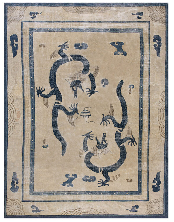 Low pile beige rug featuring two intertwined dark blue dragon figures and detailed ornamental borders.