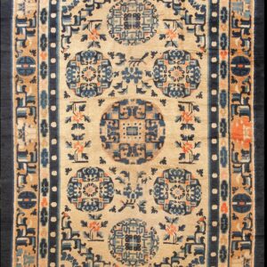 Beige rug with navy and tan borders surrounding blue geometric medallions and coral floral accents.