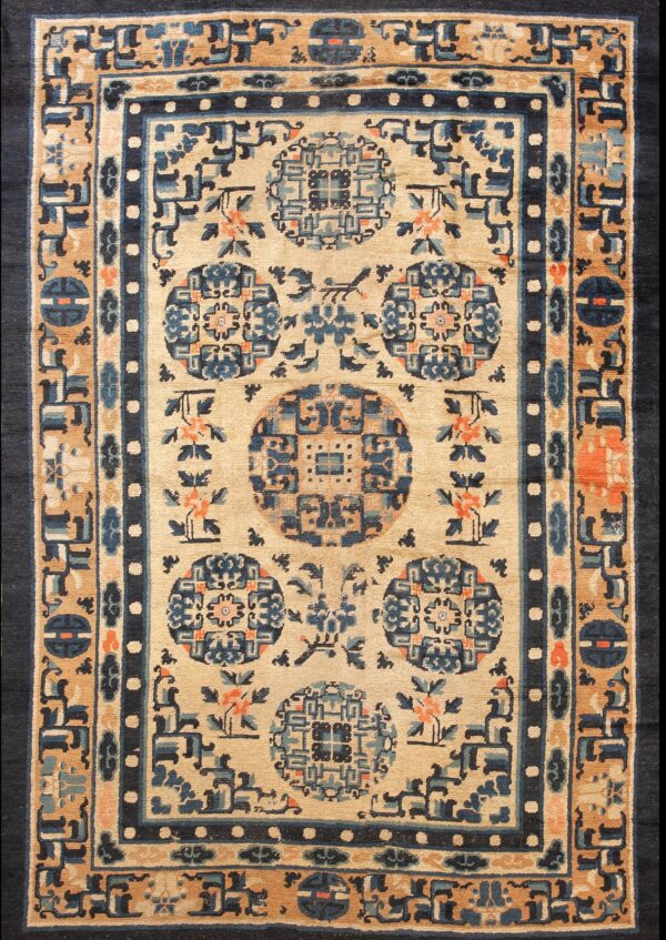 Beige rug with navy and tan borders surrounding blue geometric medallions and coral floral accents.