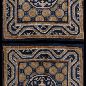 Two matching low-pile rugs in tan and navy blue with a detailed octagonal field pattern.