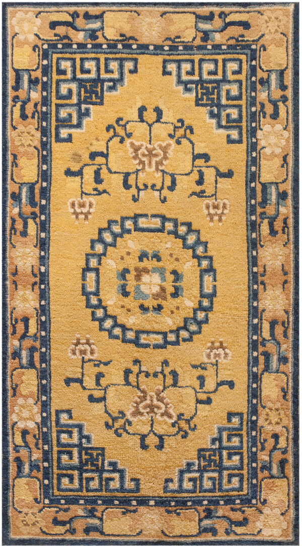 Golden yellow rug featuring a navy blue geometric medallion and coordinating tan and blue patterned borders.