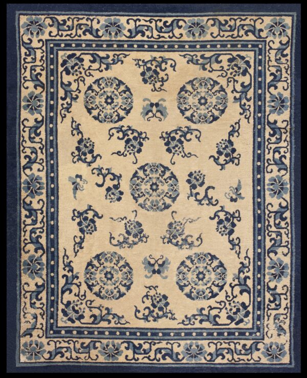 Traditional beige rug with scattered blue floral medallions and an elaborate blue border.