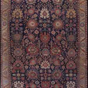 Rectangular rug with a dense traditional pattern in muted red and cream on a dark blue field.