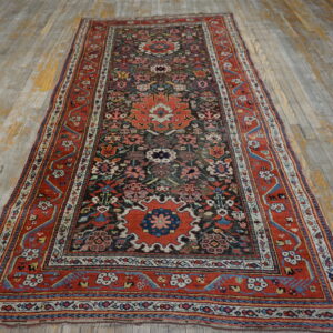 Intricate red, dark blue, and cream runner rug displayed on distressed light gray and yellow wood planks.