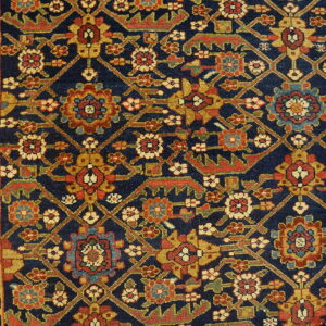 Densely patterned rug featuring a navy field, red and gold motifs, and a wide gold floral border.