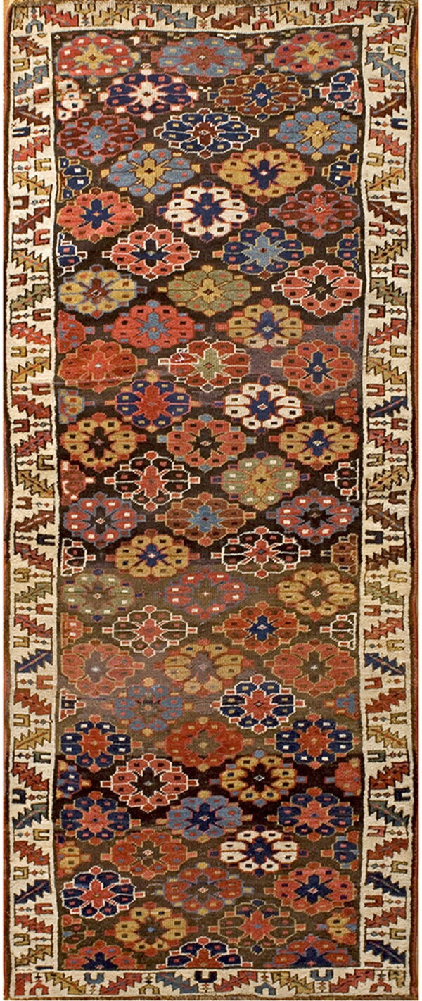 Geometric runner rug with deep red, blue, gold, and green medallions on a dark brown background and thick cream border.