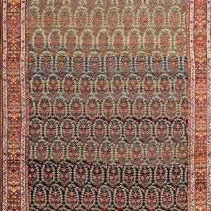 Ornate traditional rug featuring dense pink and white patterns on a dark ombre field and a wide red border.