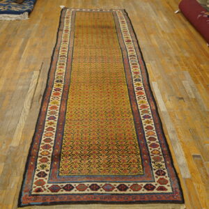 Yellow-gold geometric runner with intricate red and blue patterns, laid on distressed wood planks.