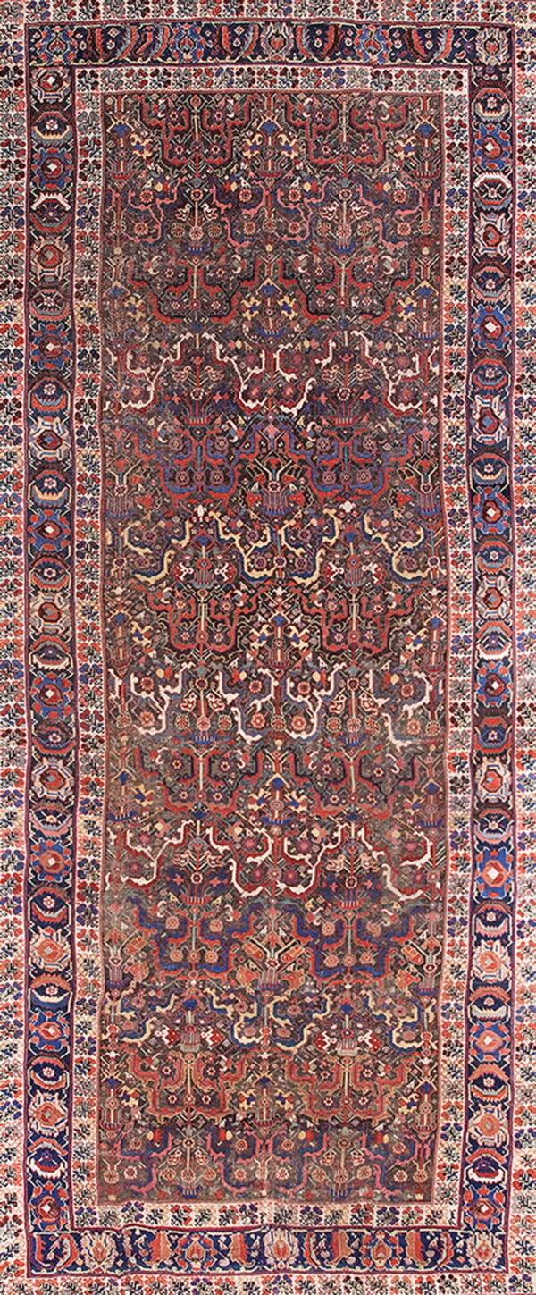 Intricate, low-pile runner rug featuring an all-over repeating pattern in deep maroon, navy, red, and cream.