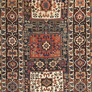 Long runner rug with complex geometric medallions in navy, rust, cream, and brown borders.