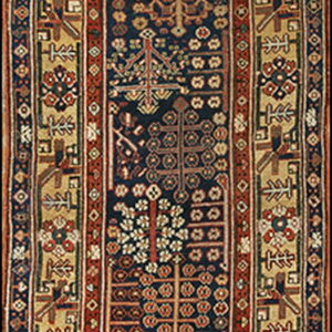 Narrow runner rug featuring a navy center field with stylized motifs bordered by red and beige geometric tribal patterns.