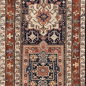 Traditional geometric runner rug with a navy blue field, centered medallions, and wide rust-colored borders.