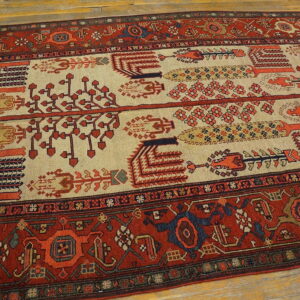 Red and cream runner rug featuring stylized repeating tribal motifs on light wood floors.