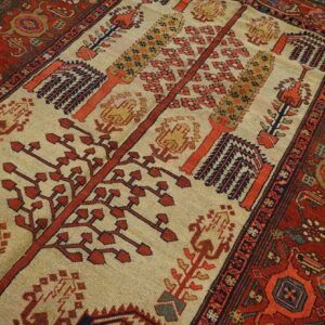 Low-pile rug with a beige center field depicting stylized red and orange trees, surrounded by a dark red border.
