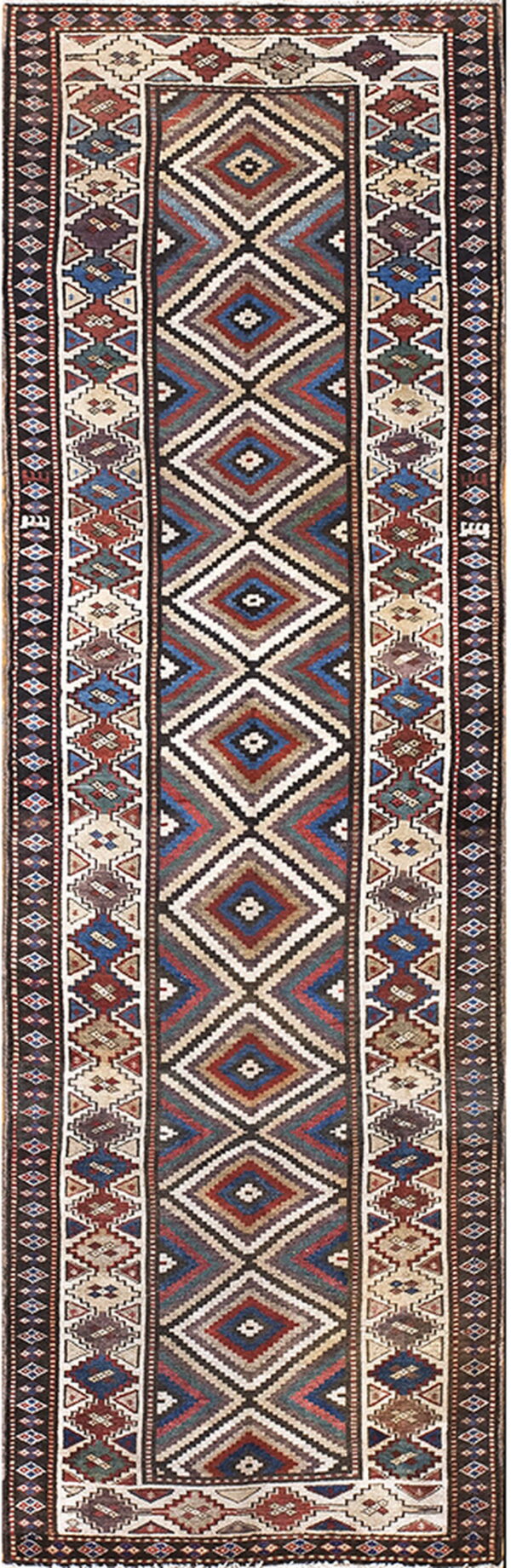 Multicolor runner rug featuring large stacked diamond motifs surrounded by detailed geometric border patterns.