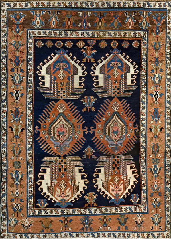 Navy blue rug with rust and cream tribal medallions surrounded by geometric multicolored borders.