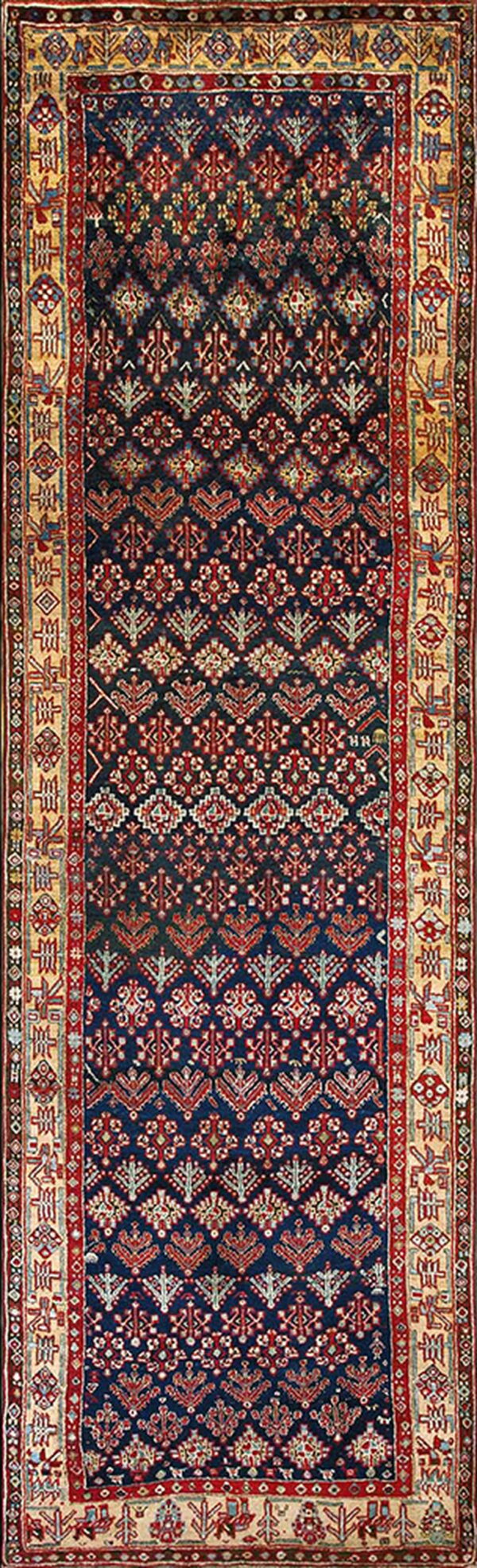 Dark blue runner rug with repeating red and cream stylized motifs and thick geometric borders.