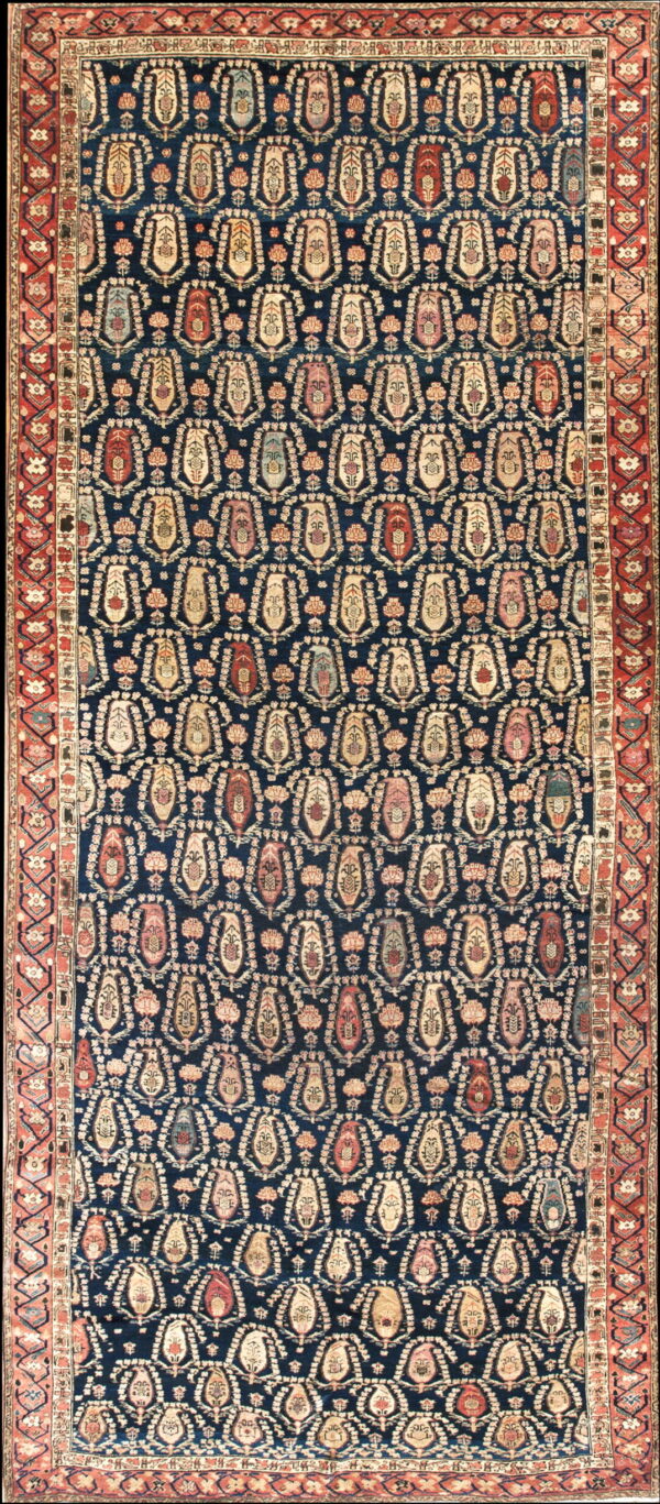 Dark blue rug with a repeating multi-colored boteh pattern and a layered red and cream border.