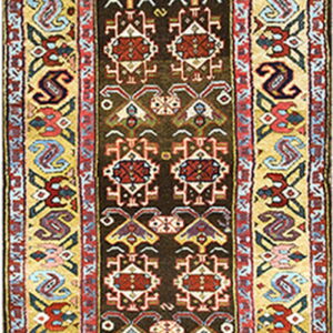 Geometric runner rug with a dark brown field patterned in red and white, framed by a wide yellow and multicolored border.