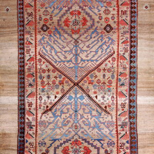 Beige runner rug with tribal blue and red geometric patterns centered on wide light brown flooring.