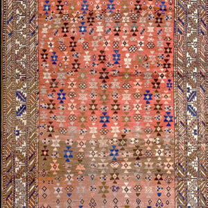 Geometric runner rug with pink and brown ground and repeating diamond patterns accented with blue and white.