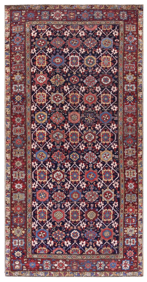 Traditional rug featuring an indigo field with colorful geometric medallions and a wide red border.