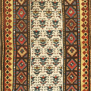 Long runner rug with a cream field and tribal patterns in deep brown, red, blue, and gold.