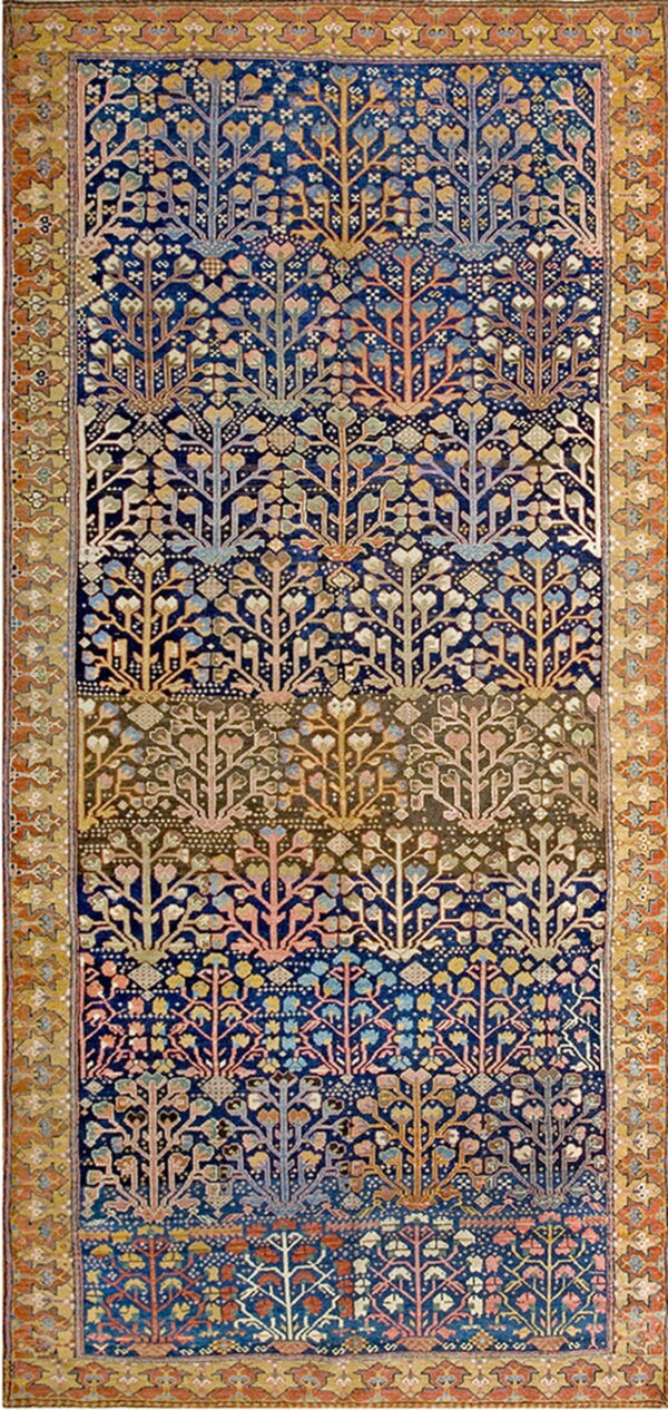 Woven rug with a dark blue and brown field showing rows of stylized multicolored tree patterns.