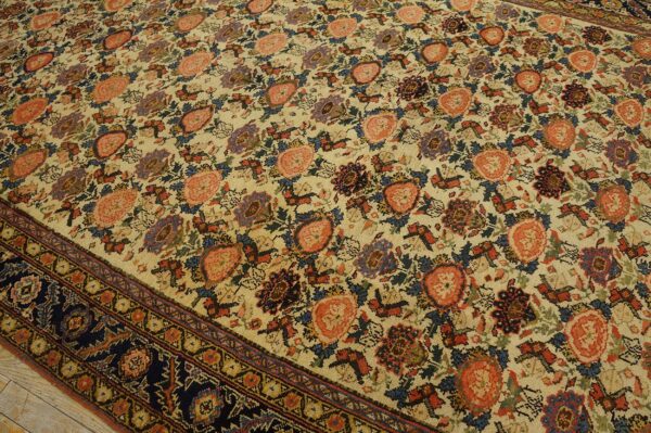 Beige ground rug featuring repeating floral medallions in coral, navy, blue, and deep red colors.