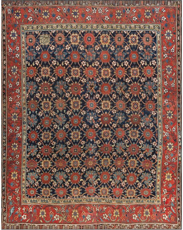 Dark blue rug featuring a repeating floral trellis design in red, blue, and ochre, surrounded by a wide rust-colored border.