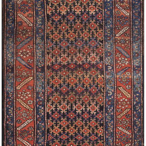 A geometric runner rug featuring a dark field of repeating crosses and a wide rust border.