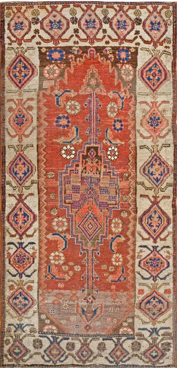 Red and blue geometric tribal rug featuring a stepped central motif and wide beige borders.