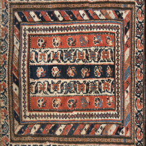 Rust and navy tribal rug featuring horizontal medallion bands framed by geometric borders.