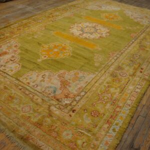 Chartreuse green, high-pile rug with ornate yellow and pink medallion patterns on rustic wood plank flooring.