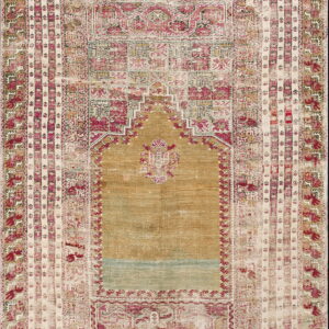 Distressed rug featuring a central gold arch design surrounded by detailed rose, cream, and pale green borders.