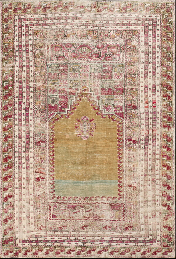Distressed rug featuring a central gold arch design surrounded by detailed rose, cream, and pale green borders.