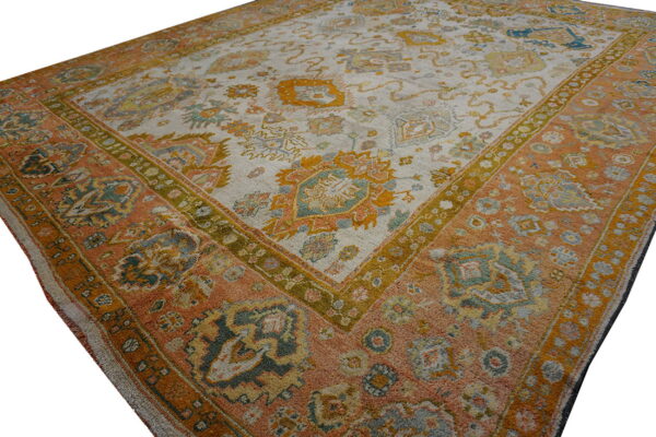 Square-format rug featuring a distressed traditional pattern in rust, mustard, sage, and pale beige.
